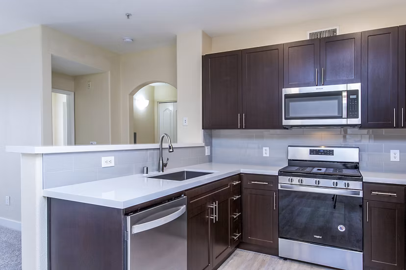 Modern kitchen with sleek countertops and stainless steel appliances at Waterford Place Apartments