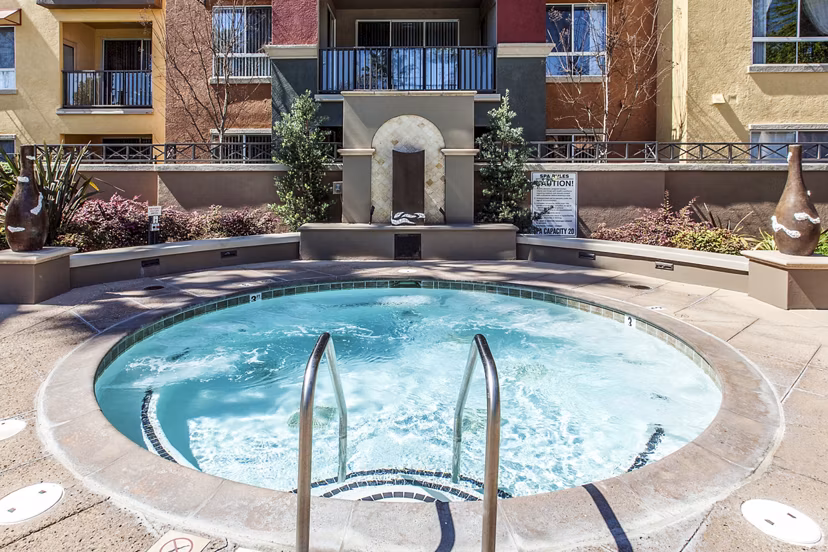 Hot tub with lush garden view at Waterford Place Apartments, part of Greystar luxury living