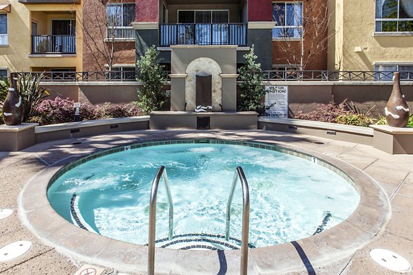 Hot tub with lush garden view at Waterford Place Apartments, part of Greystar luxury living