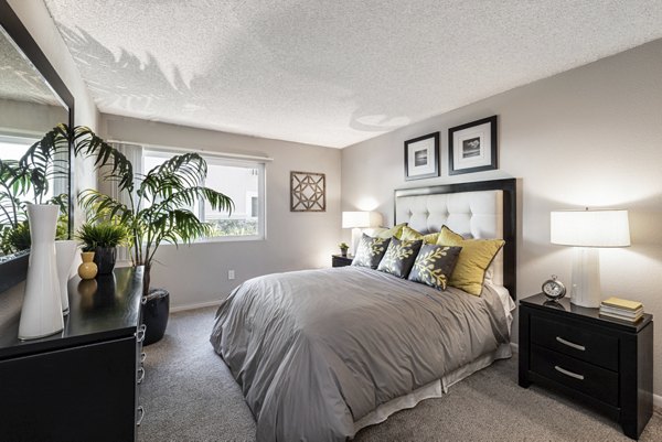 Cozy bedroom with stylish decor at The Breakwater Apartments