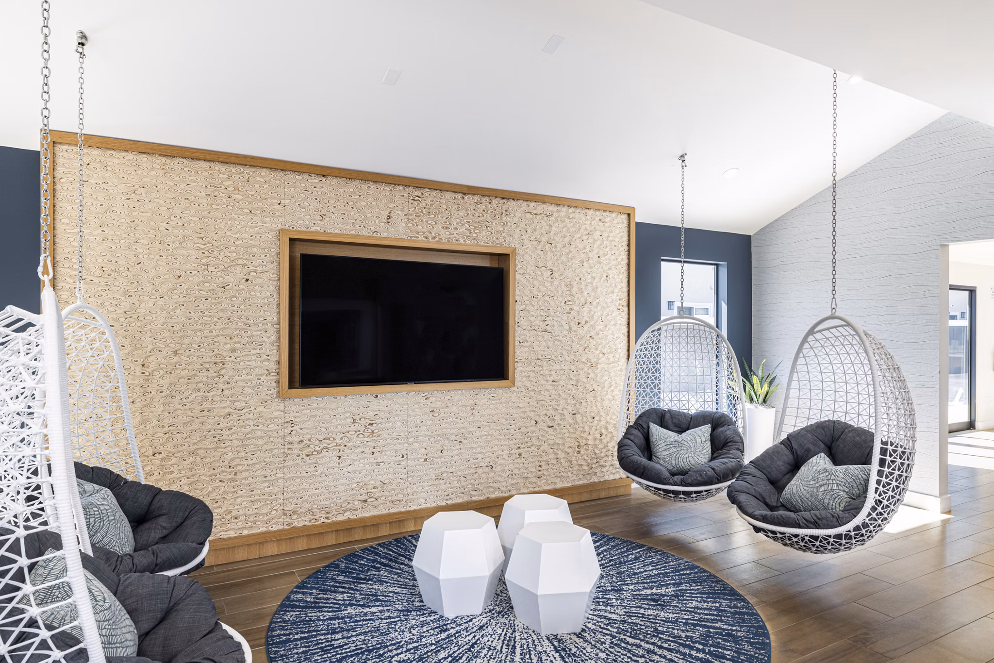 Clubhouse interior with modern lounge seating and large windows at The Breakwater Apartments, a Greystar luxury community