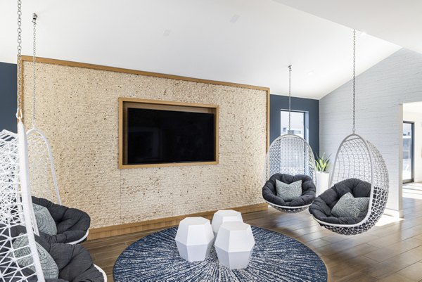 Clubhouse interior with modern lounge seating and large windows at The Breakwater Apartments, a Greystar luxury community