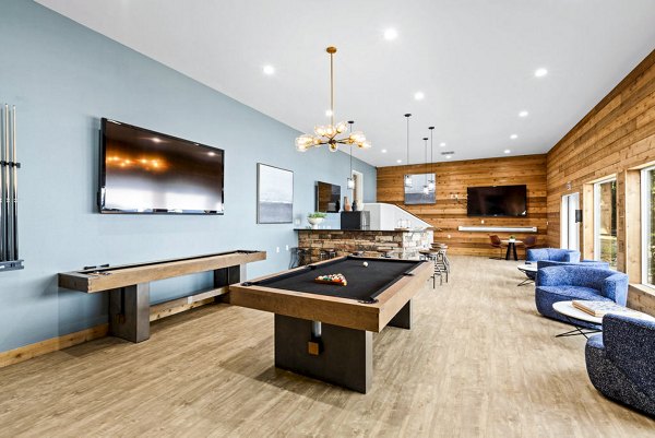 Clubhouse game room with billiards and seating at Avana Chestnut Hills Apartments, ideal for social gatherings and entertainment