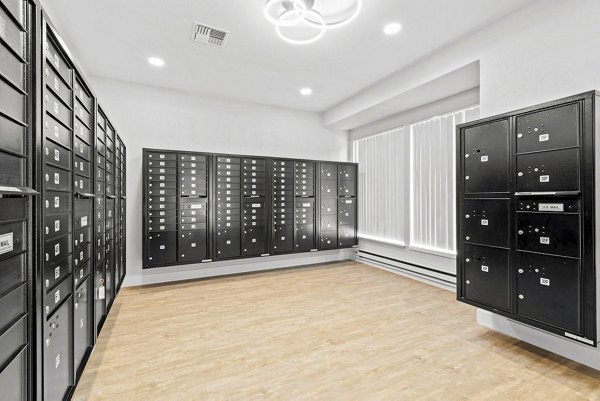 Avana Chestnut Hills: Modern clubhouse mail room with organized mailboxes and parcel lockers in luxury apartment community