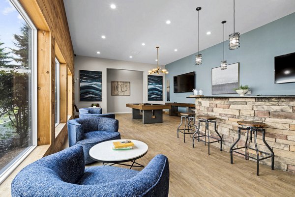 Clubhouse game room with billiards and lounge seating at Avana Chestnut Hills Apartments