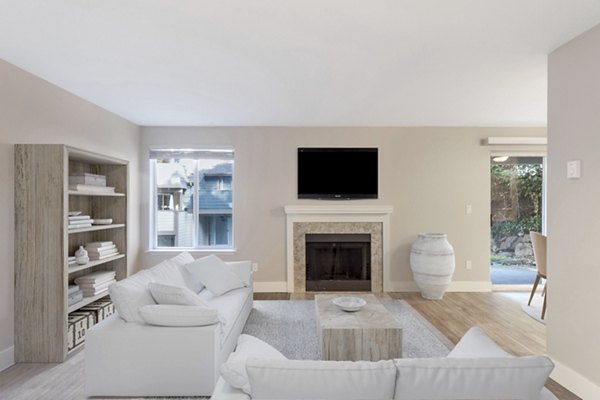 Living room with modern decor and large windows at Avana Chestnut Hills Apartments