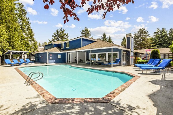 Outdoor swimming pool with lounge chairs at Avana Chestnut Hills Apartments, perfect for relaxation and leisure activities