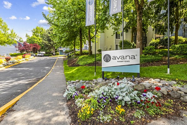 Welcome sign at Avana Hamptons luxury apartments, elegant entrance in a lush suburban setting