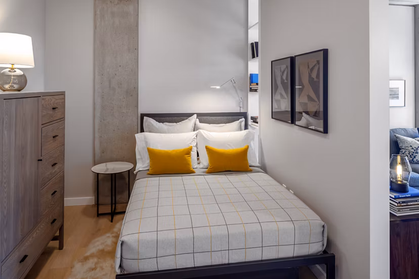 Elegant bedroom with modern furnishings at The Payton Apartments, offering luxury living spaces in a prime location