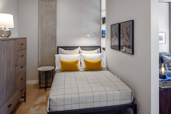 Elegant bedroom with modern furnishings at The Payton Apartments, offering luxury living spaces in a prime location