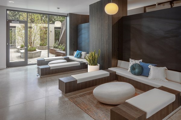 Clubhouse with modern seating and large TV at The Payton Apartments