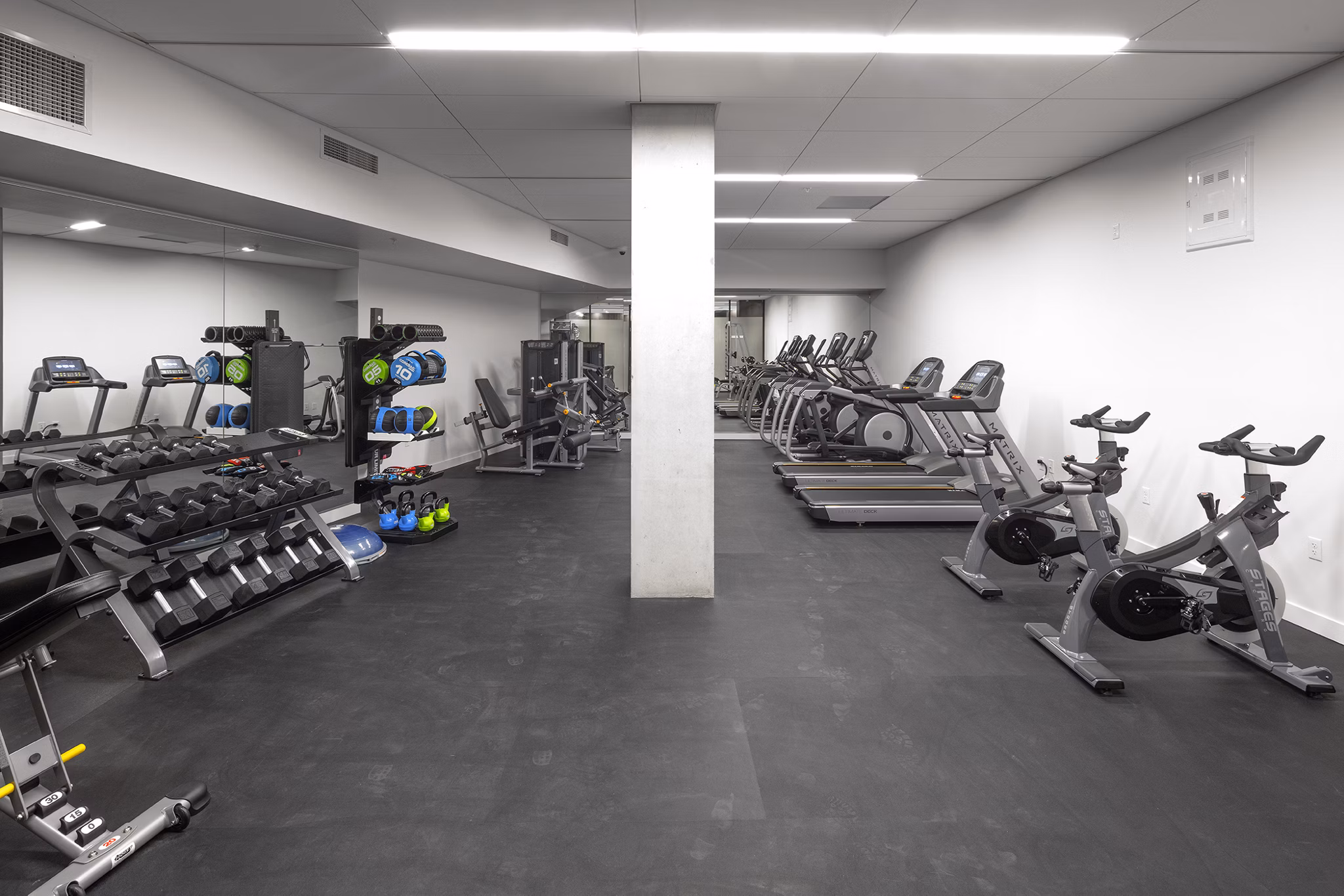 State-of-the-art fitness center featuring modern equipment at The Payton Apartments, perfect for active lifestyles and wellness-focused living