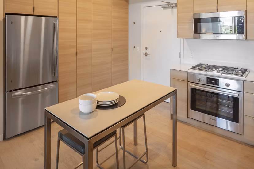 Modern kitchen with stainless steel appliances in The Payton luxury apartments, ideal for contemporary living in a vibrant community