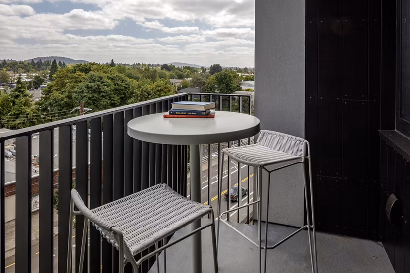 The Payton Apartments: Relaxing patio with comfortable seating and lush greenery
