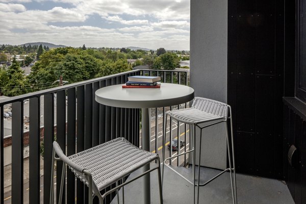 The Payton Apartments: Relaxing patio with comfortable seating and lush greenery
