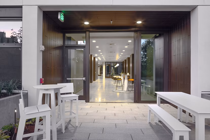 Spacious patio with modern seating and greenery at The Payton Apartments, luxury living by Greystar
