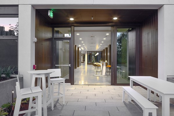 Spacious patio with modern seating and greenery at The Payton Apartments, luxury living by Greystar