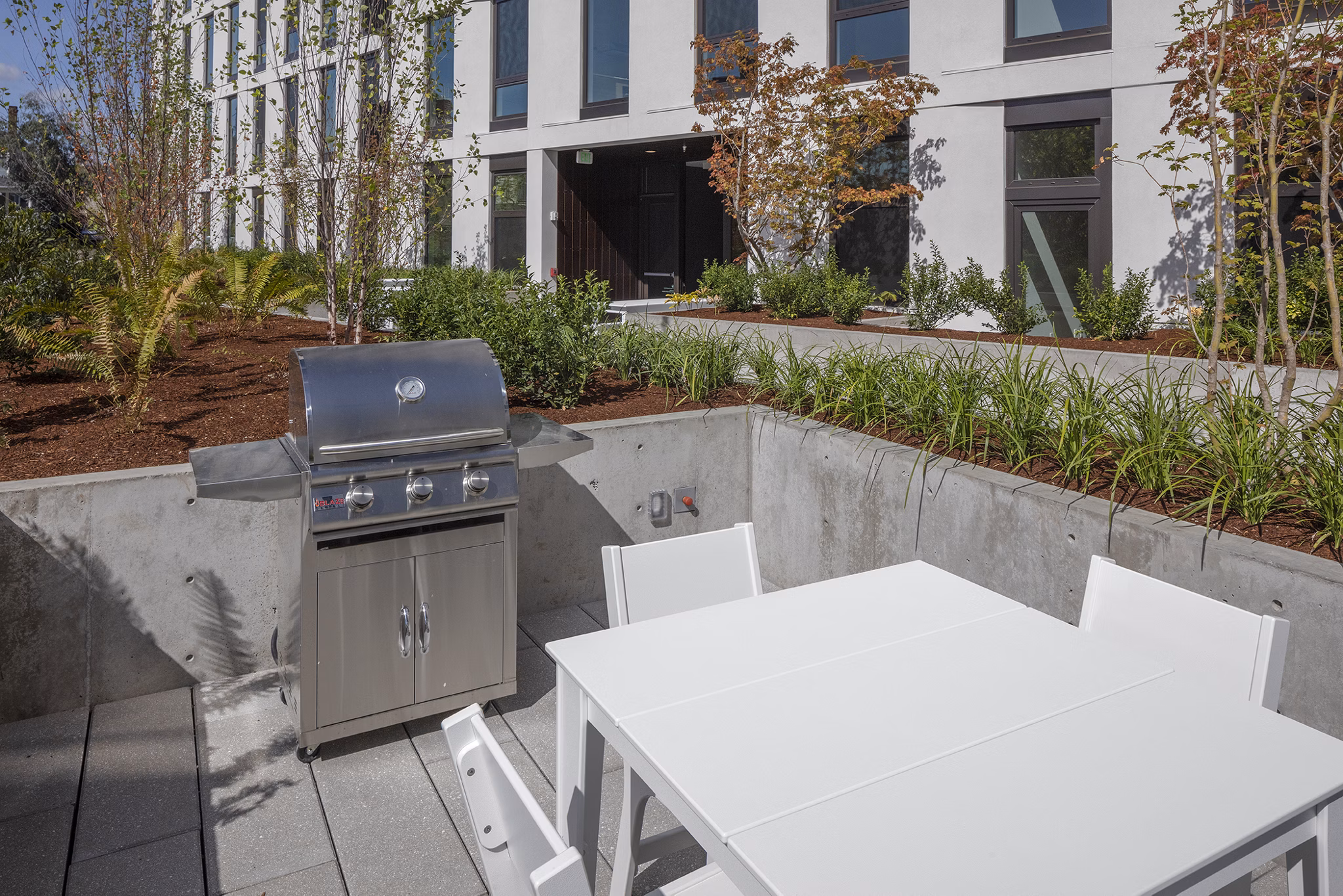 Grill area featuring modern outdoor seating at The Payton luxury apartments
