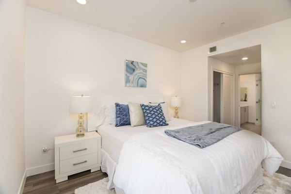 Inviting bedroom with plush bedding and stylish decor in One38 Apartments