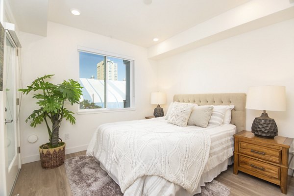 Modern bedroom with sleek furnishings and city views at One38 Apartments, luxury living in the heart of a vibrant urban community