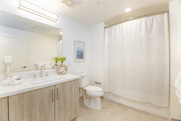 Luxurious bathroom with modern fixtures in One38 Apartments, featuring sleek vanity and spacious shower