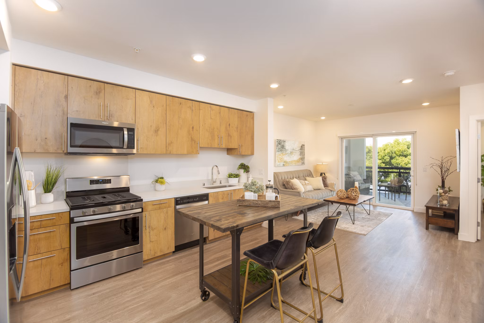 Modern kitchen with stainless steel appliances and marble countertops in One38 Apartments