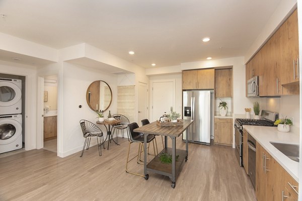 Stylish kitchen with stainless steel appliances at One38 Apartments, by Greystar