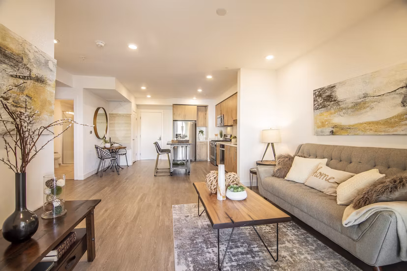 Spacious living room with modern decor and large windows at One38 Apartments, offering luxury living in an exclusive community