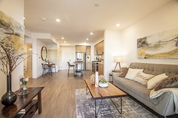 Spacious living room with modern decor and large windows at One38 Apartments, offering luxury living in an exclusive community