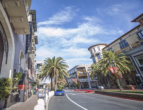 One38 Apartments: Vibrant neighborhood view featuring tree-lined streets and urban landscape, offering a lively atmosphere for residents