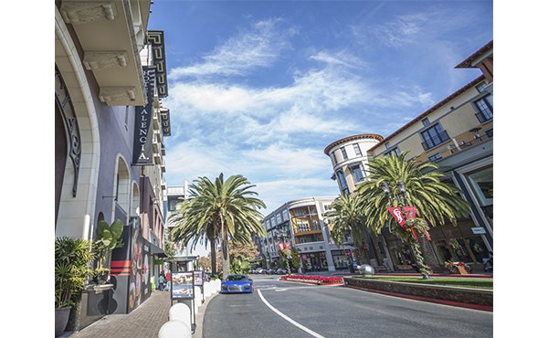 One38 Apartments: Vibrant neighborhood view featuring tree-lined streets and urban landscape, offering a lively atmosphere for residents