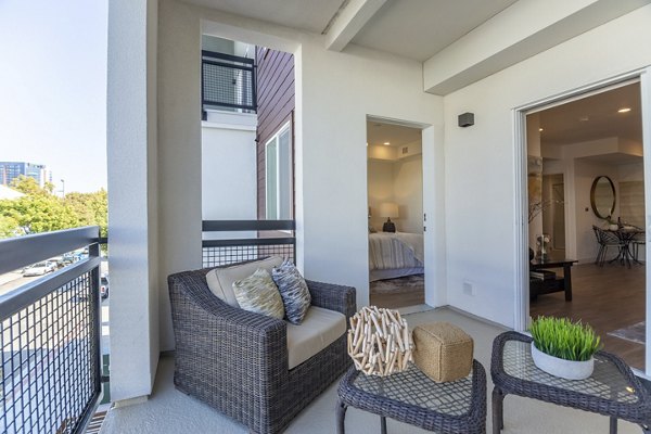 Modern patio with seating and lush greenery at One38 Apartments, offering a luxurious outdoor living space for residents