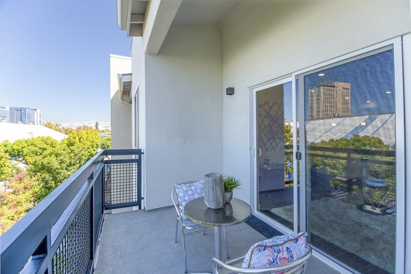 Patio with modern seating and urban views at One38 Apartments