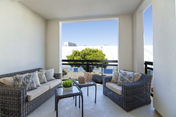 Spacious patio with modern furniture at One38 Apartments offering luxury and comfort for outdoor relaxation