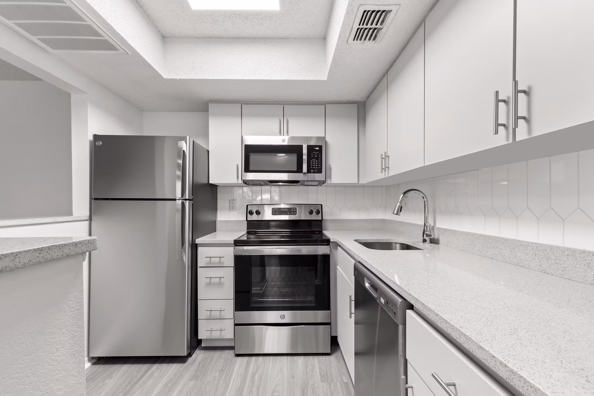 Modern kitchen with stainless steel appliances in Avana Coachman Apartments