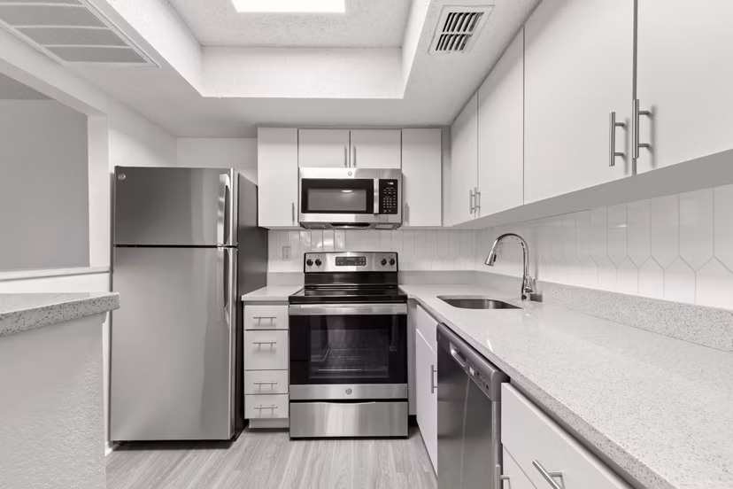Modern kitchen with stainless steel appliances in Avana Coachman Apartments