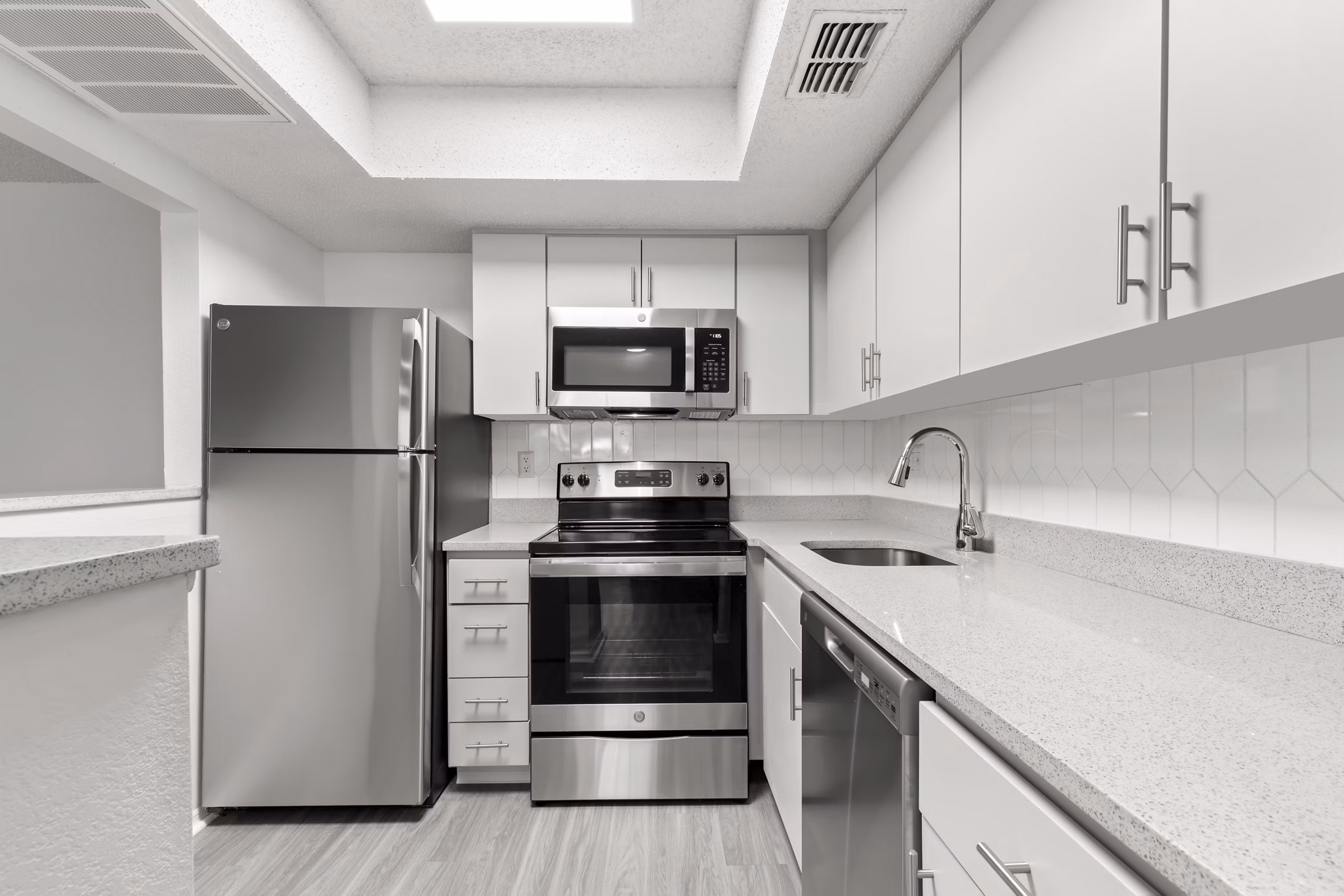 Modern kitchen with stainless steel appliances in Avana Coachman Apartments
