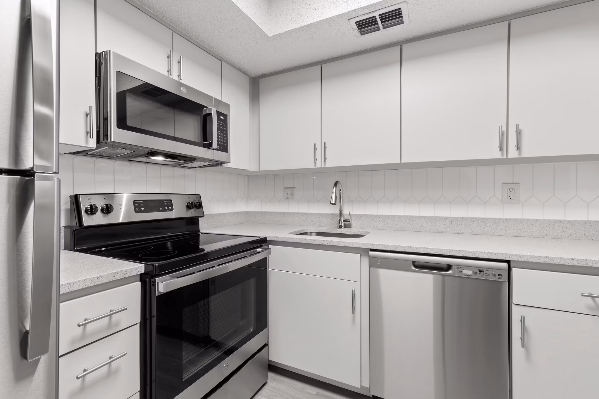 Modern kitchen with stainless steel appliances at Avana Coachman Apartments