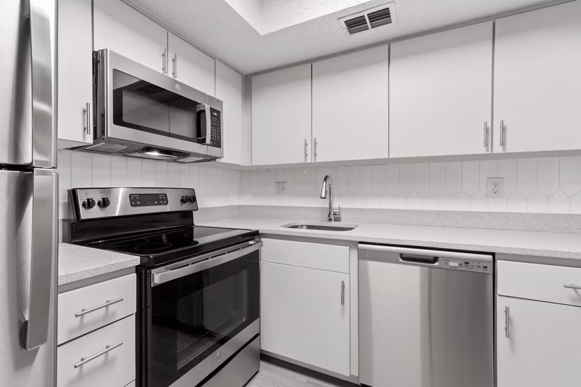 Modern kitchen with stainless steel appliances at Avana Coachman Apartments