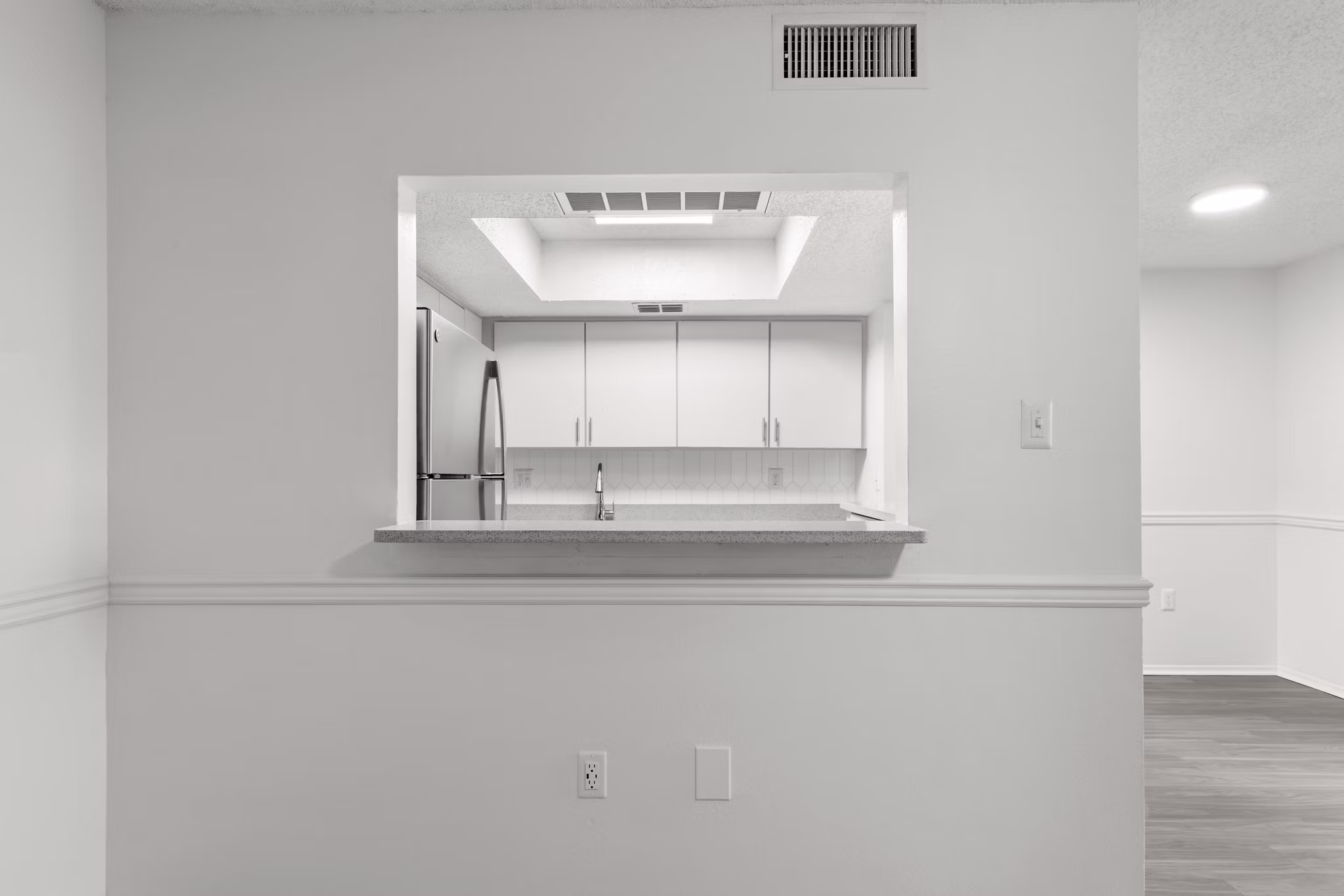 Modern kitchen with stainless steel appliances and granite countertops at Avana Coachman Apartments
