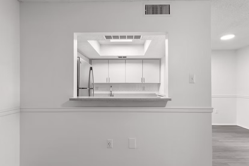 Modern kitchen with stainless steel appliances and granite countertops at Avana Coachman Apartments