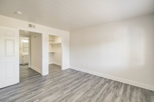 Comfortable bedroom with plush bedding and modern decor in Copper Terrace Apartments