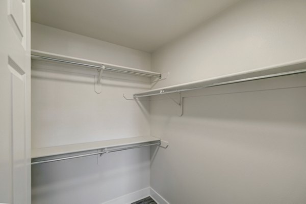 Walk-in closet with ample storage space in Copper Terrace Apartments