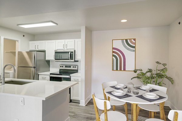 Dining area featuring modern seating and lighting at Copper Terrace Apartments, a luxury Greystar community