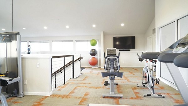 Modern fitness center with cardio and weight equipment at Copper Terrace Apartments