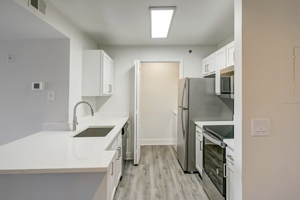 Modern kitchen with stainless steel appliances at Copper Terrace Apartments