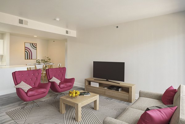 Spacious living room with modern decor in Copper Terrace Apartments, featuring Greystar luxury touches for comfortable living