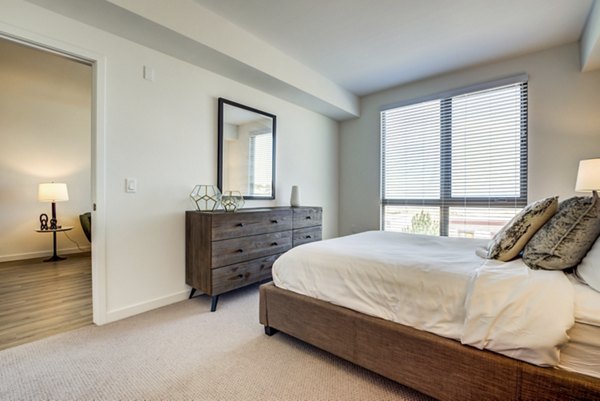 Cozy bedroom with modern decor at The Exchange at Bayfront Apartments