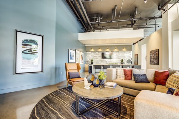 Modern clubhouse with cozy seating at The Exchange at Bayfront Apartments