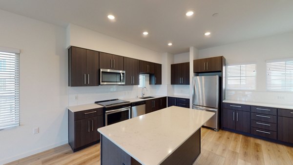 Modern kitchen with stainless steel appliances at The Exchange at Bayfront Apartments